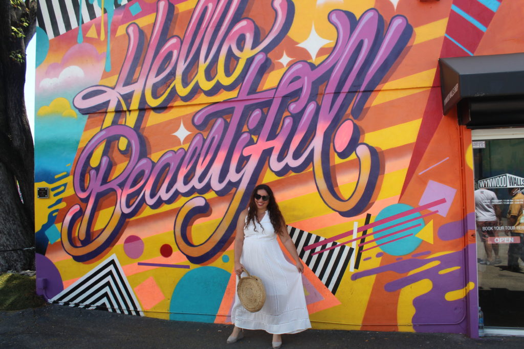 wearing a white Madewell dress, Castaner wedges, and Zara woven circle bag at the Hello Beautiful mural in Wynwood