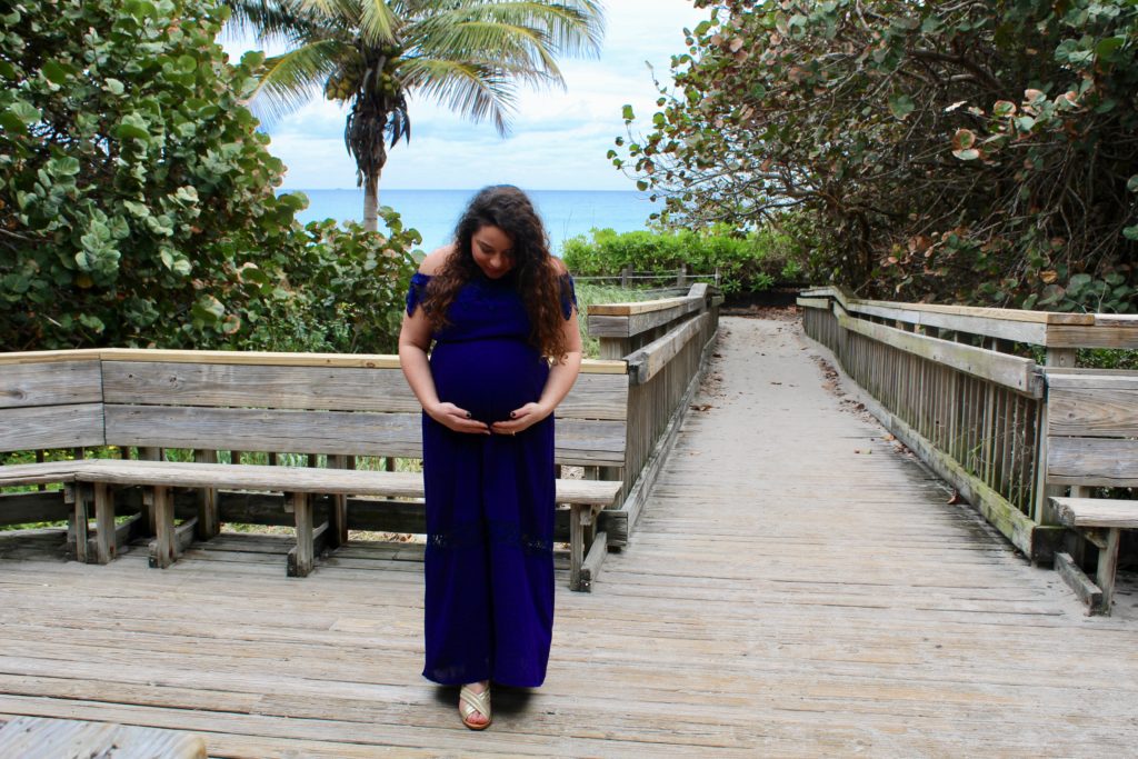 beach boardwalk maternity picture looking down at belly