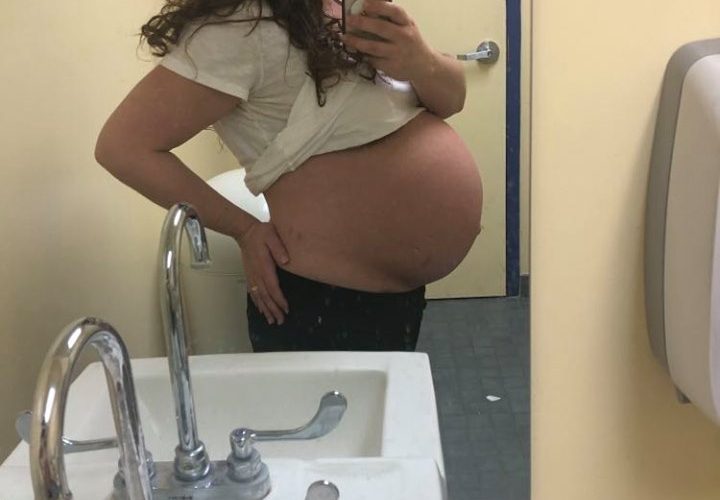 mirror selfie showing 39 week pregnant belly