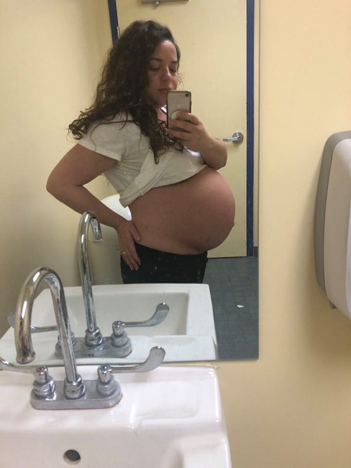 mirror selfie showing 39 week pregnant belly