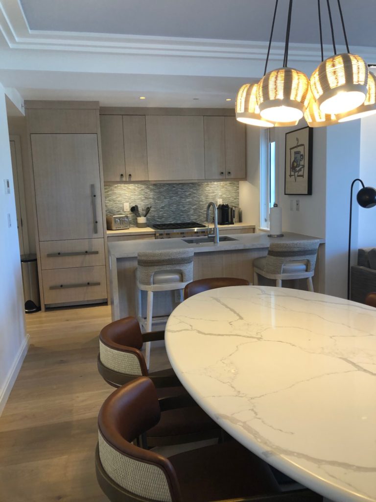 dining room and full kitchen in white elephant palm beach suite