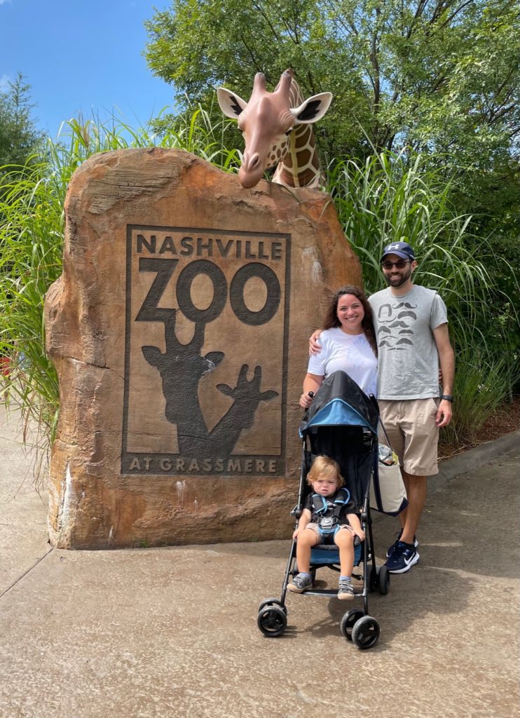 family posing in front of the Nashville Zoo Entrance 