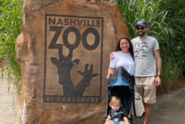 family posing in front of the Nashville Zoo Entrance
