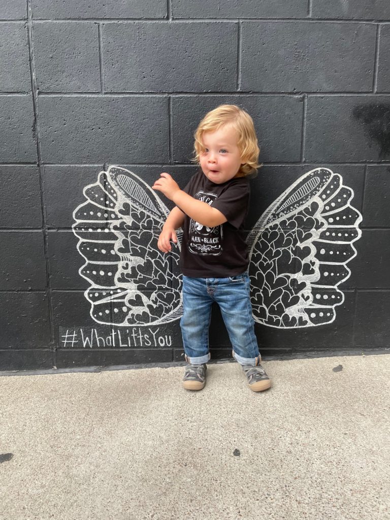 Toddler in front of the #whatliftsyou mural in Nashville